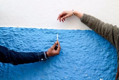 Close-up of hand smoking on water