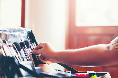 Close-up of man holding brushes