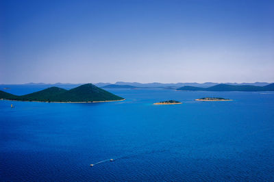 Scenic view of sea against clear blue sky