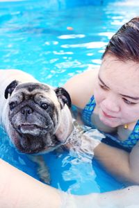 High angle view of woman with dog in pool