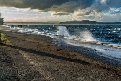 A view of the shoreline on a stormy day at alki beach in west seattle, washington.