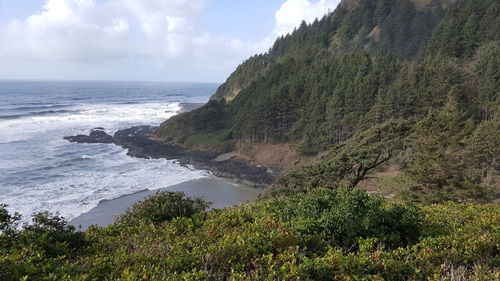 Scenic view of tree mountains and sea against sky