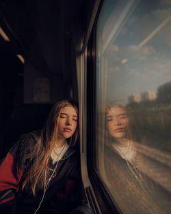 Low angle view of woman sitting in train