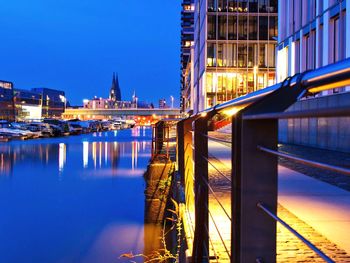 Bridge over river in city at night