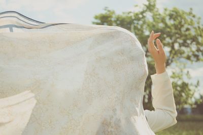 Midsection of woman holding umbrella