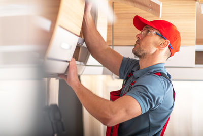 Side view of man working in office