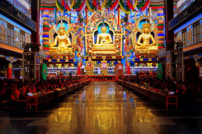 Statue of illuminated temple in building
