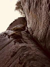 Low angle view of rock formation against sky