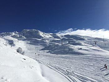 Scenic view of snow covered mountains against sky