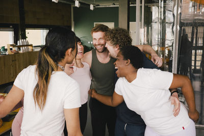 Cheerful multiracial colleagues enjoying at office