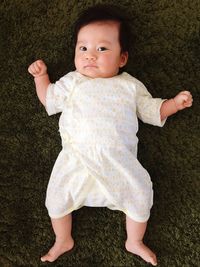 High angle view of baby boy lying on floor