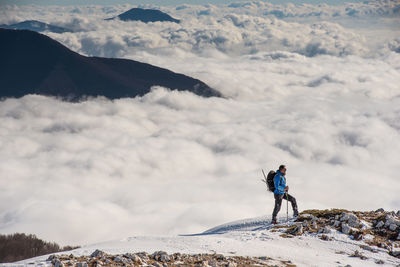 Man standing on mountain against sky