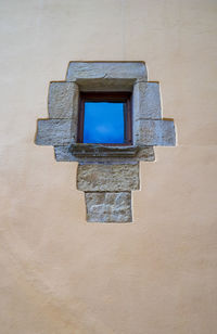 Low angle view of window on wall