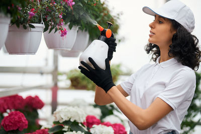 Midsection of woman holding flowering plants