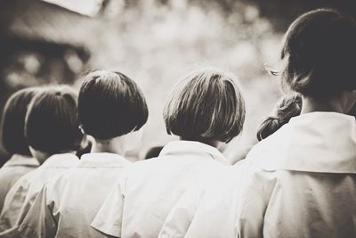 Rear view of girls standing