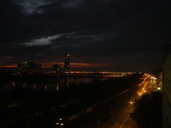 Illuminated city against sky at night