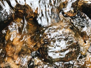 High angle view of river flowing through rocks