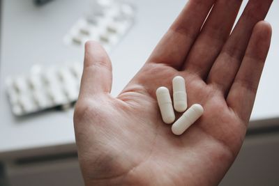 Close-up of human hand holding pills 