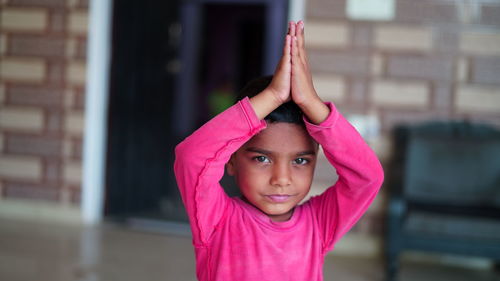 Portrait of happy girl in pink outdoors