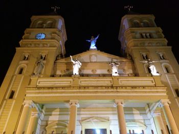 Low angle view of illuminated building against sky at night