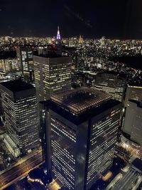 High angle view of illuminated buildings in city at night