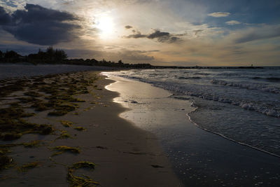 Scenic view of beach against sky during sunset