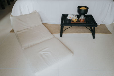 High angle view of empty chair on table at home