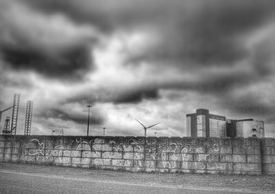 Low angle view of windmill against cloudy sky