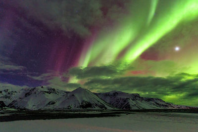 Scenic view of landscape against sky at night