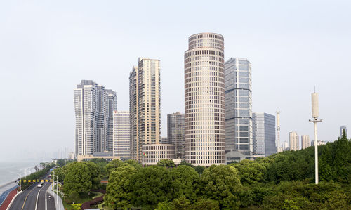 Buildings in city against clear sky