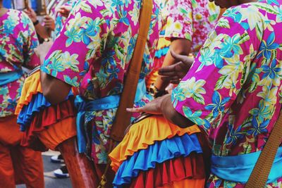 Low angle view of people dancing in multi colored umbrellas