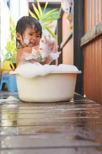 Cute girl taking a bath in tub at home 