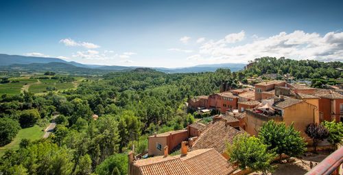 High angle view of trees and buildings against sky