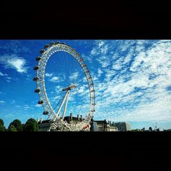 Low angle view of ferris wheel against sky