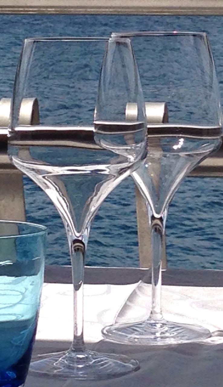 water, table, sea, indoors, drinking glass, refreshment, drink, absence, food and drink, still life, empty, chair, day, no people, sunlight, nautical vessel, transparent, close-up, blue, horizon over water