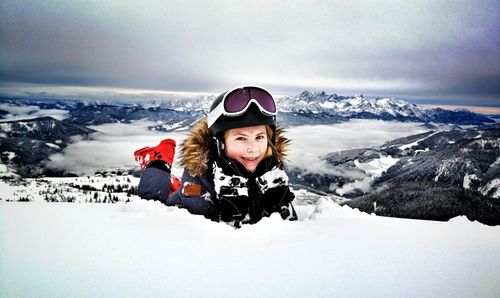 Portrait of woman on snowcapped mountains against sky