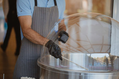 Close-up of man working at glass