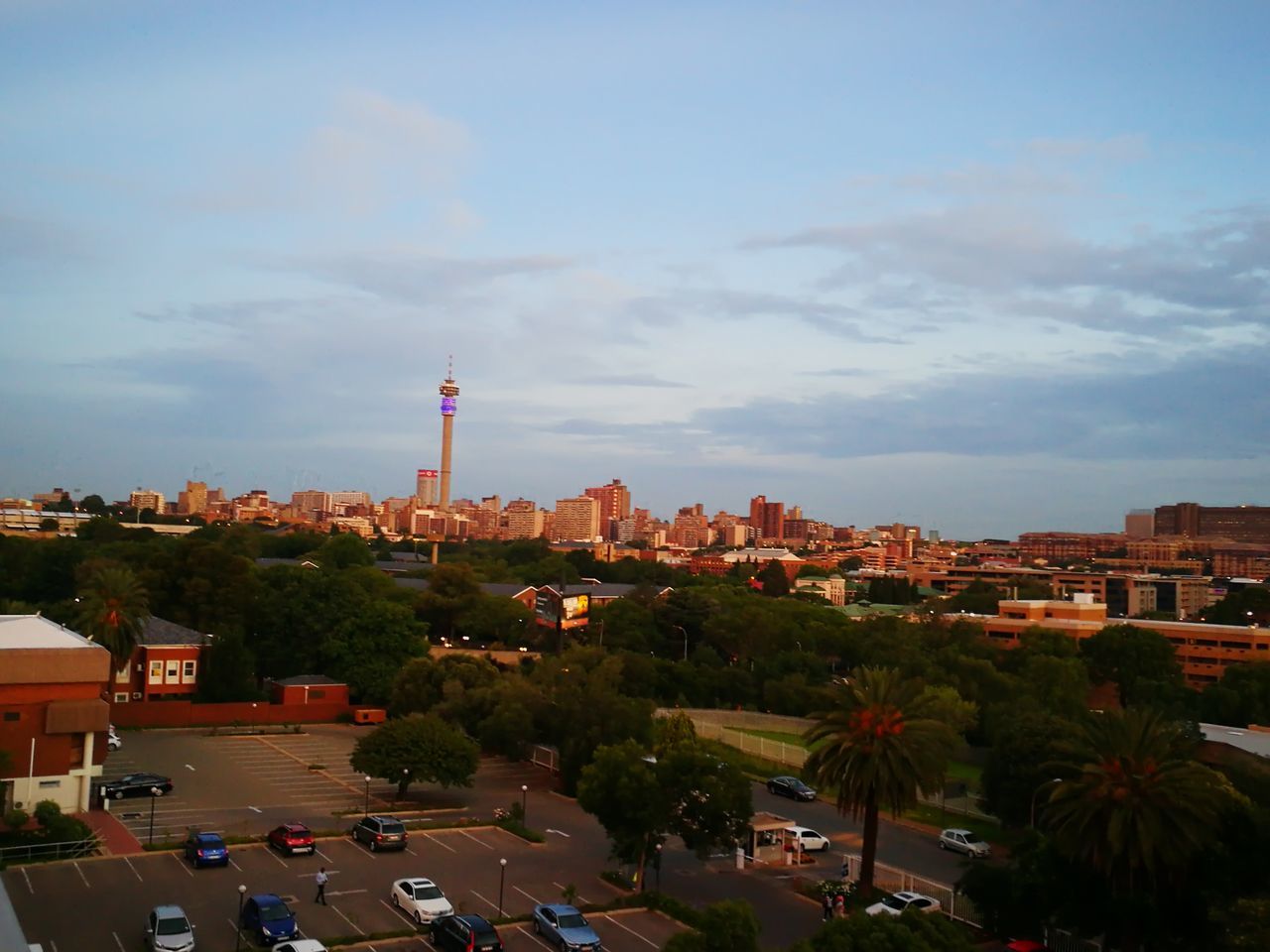 city, building exterior, architecture, built structure, sky, cityscape, cloud - sky, tree, tower, growth, outdoors, residential building, urban skyline, no people, skyscraper, nature, day