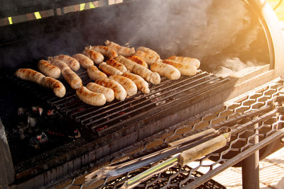 Grilled meat sausages on charcoal grill, outdoor picnic