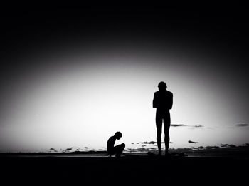 Silhouette of woman standing on beach