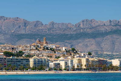 Altea, with church dominating the view of the town and a mountain range,, costa blanca, spain.