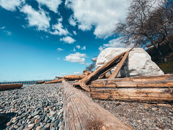 Stack of rocks by trees against sky