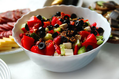 Closeup summer salad. classic greek salad from tomatoes, cucumbers, red pepper, onion with olives