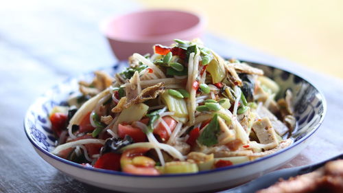 Close-up of food in plate on table papaya salad