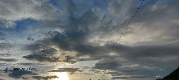 Low angle view of sign against sky at sunset