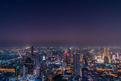 Illuminated buildings in city at night