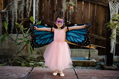 Young girl in dress up posing outdoors