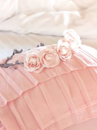 Close-up of pink rose on bed