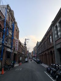 City street amidst buildings against sky