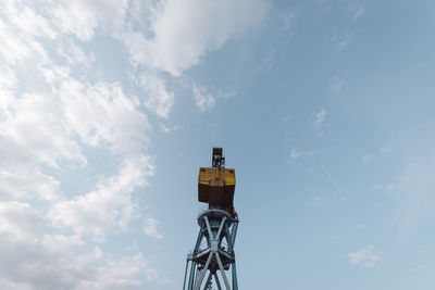 Low angle view of crane against sky